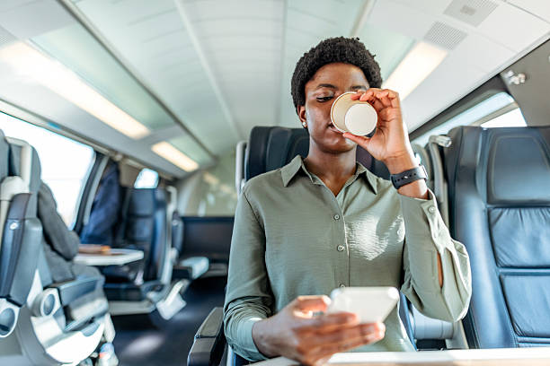 istock Professional Woman Drinking Coffee and Using Smartphone on Comfortable Train Journey 2222983063