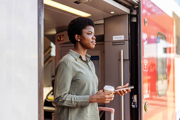 istock Profile of Woman With Coffee Exiting Train During Daylight Hours 2222983076