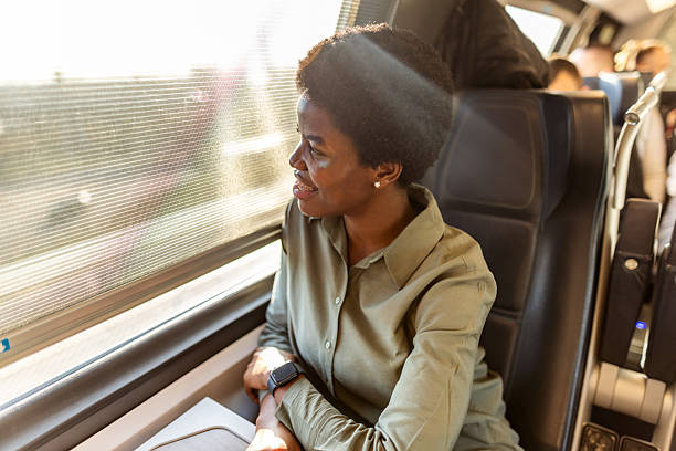 istock Woman Enjoying Scenic Train Ride While Looking Out Window Smiling 2222983102