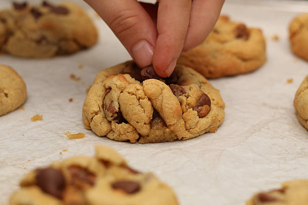 istock Adding chocolate chips to freshly baked cookies 2222989478