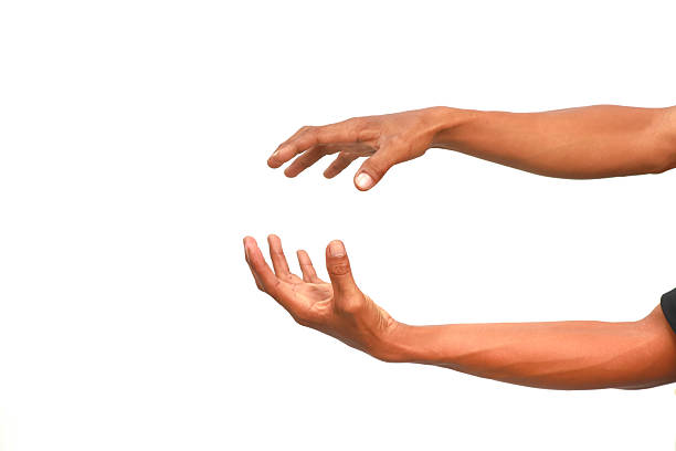 istock Two outstretched hands, one above the other, with a man's arms on a clean white background, creating a sense of reaching or offering 2222991211