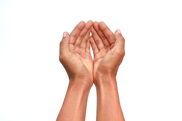 istock Human hands cupped together in a gesture of offering or supplication on white backdrop 2222991871