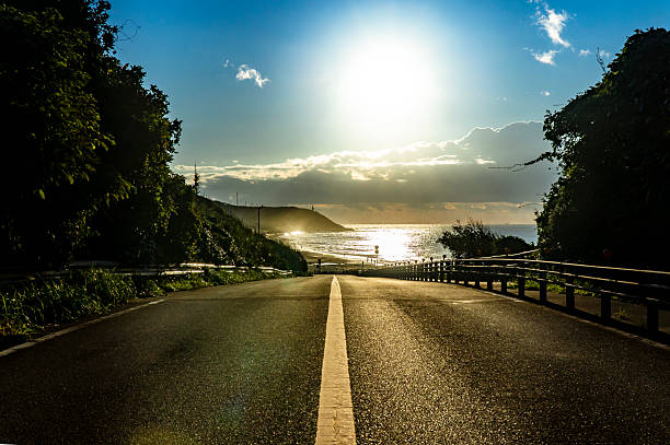 istock A straight road along the sea at dawn. 2222992565
