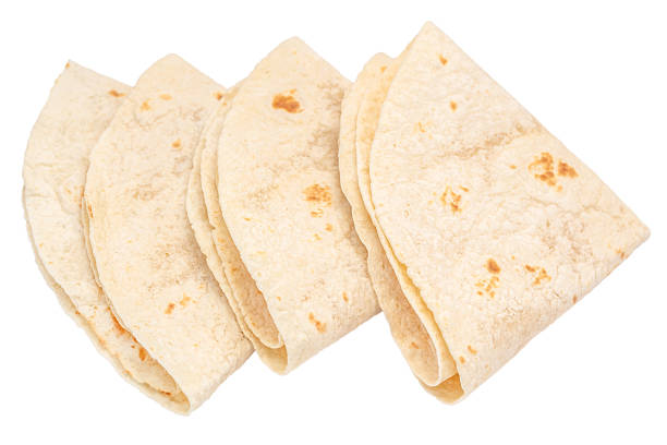 Mexican snack corn dough picadas stacked at a food market stall in Atlixco, Puebla.