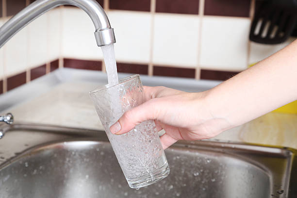 istock Glass filled with water from faucet 2222998019