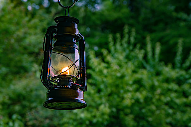istock Oil lamp burning with a soft glow light in forest. 2222998041