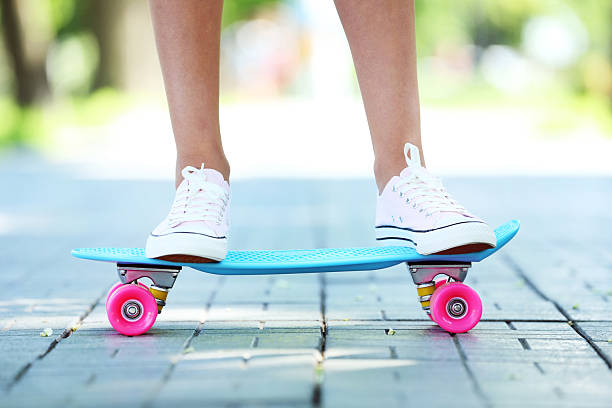 istock Girl standing on skateboard in the park 2222998191