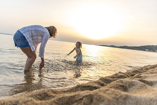 istock Mother and son having fun on the beach 2222999468
