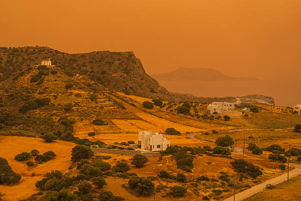 wind with sahara dust blowing over greek island of crete coloring everything in orange