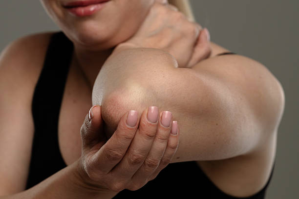 istock Woman Massaging Her Elbow to Relieve Discomfort 2223007711