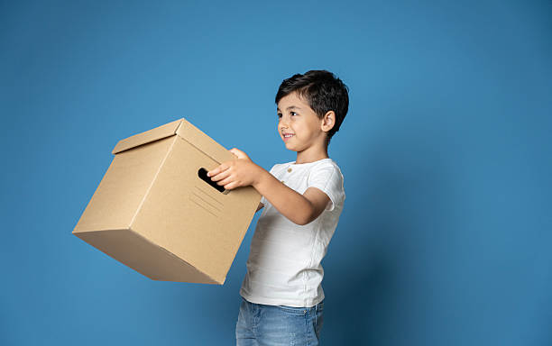Portrait Of Boy Holding Toys Against White Background