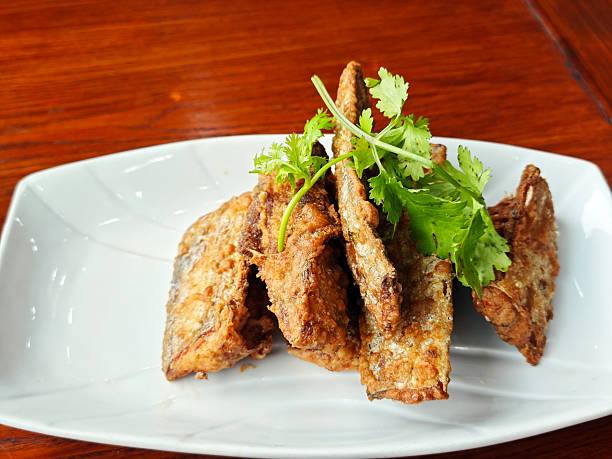 istock dry fried ribbon fish  with vegetables on the white plate 2223008627