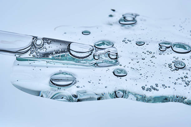 istock A puddle of transparent serum with microneedles on a blue background. 2223012841