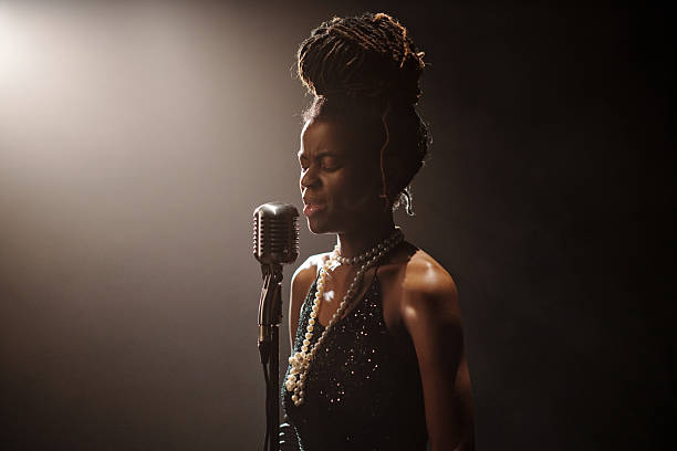 istock Young Female Musician Singing Jazz Music into Microphone on Stage 2223013502