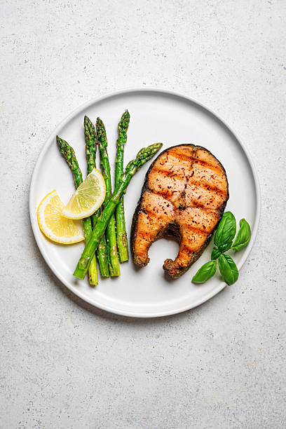 istock Grilled salmon steak with green asparagus and lemon slices 2223014108