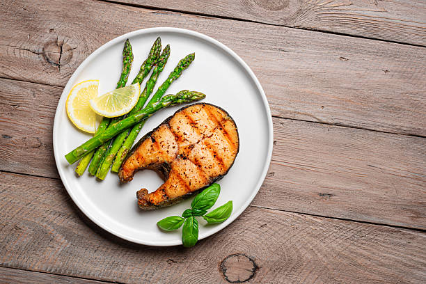 istock Grilled salmon steak with roasted green asparagus 2223014170