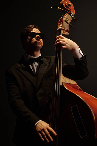 istock Caucasian Middle Aged Man Playing Double Bass during Jazz Performance on Stage 2223015842