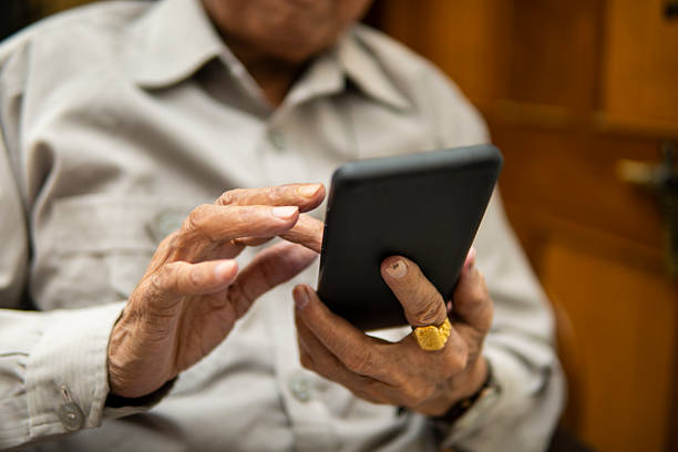 istock close up of retired senior man using a smartphone at home. 2223016623