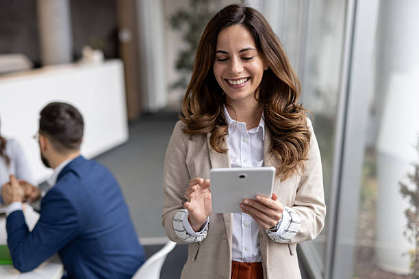 istock Smiling businesswoman using digital tablet in modern office 2223016726