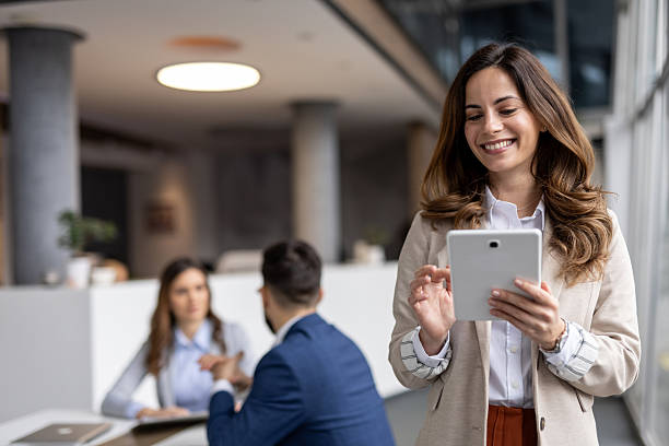 istock Smiling businesswoman using digital tablet in modern office 2223016802