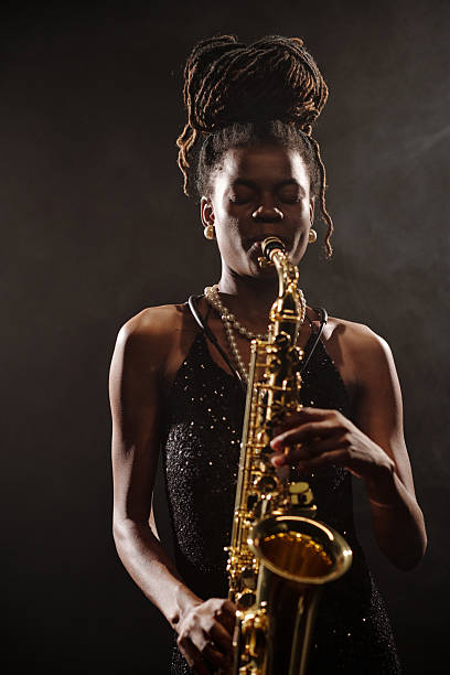istock Young Black Woman Expressing Emotion While Playing Saxophone on Stage 2223019301