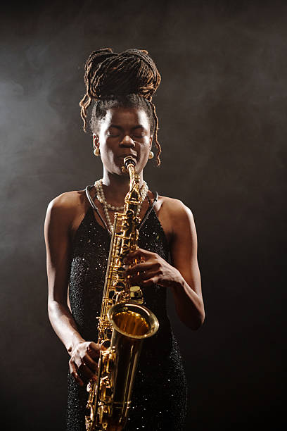 istock Young Female Musician Playing Saxophone Immersed in Jazz Performance 2223019650