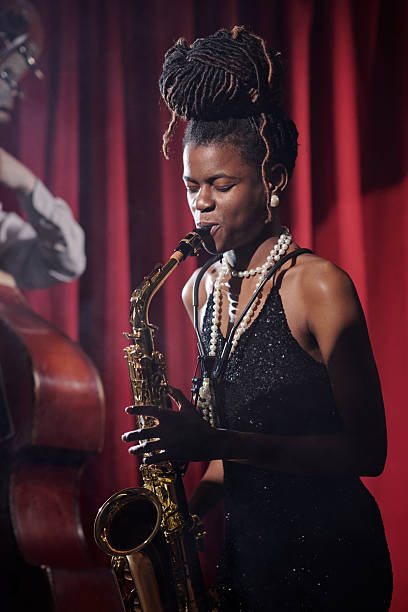 istock Young Female Musician Playing Saxophone on Stage during Jazz Performance 2223020193