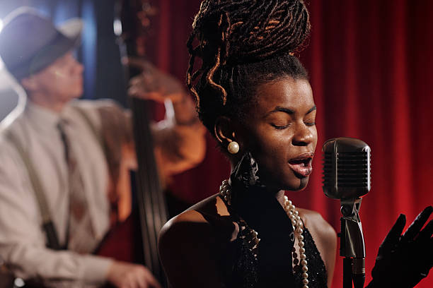 istock Black Woman Singing Jazz into Microphone during Live Performance 2223020628