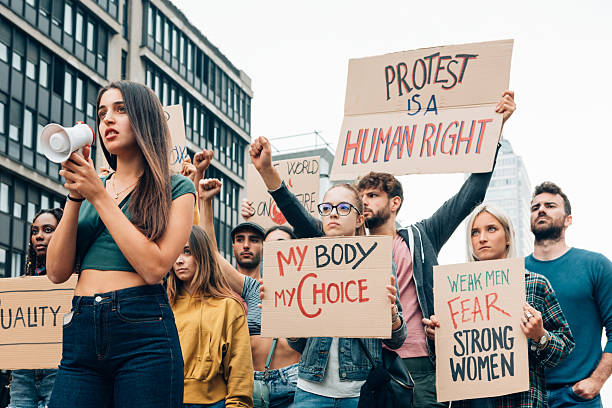 istock Crowd protesting for human rights, women empowerment and abortion rights holding protest signs 2223020702