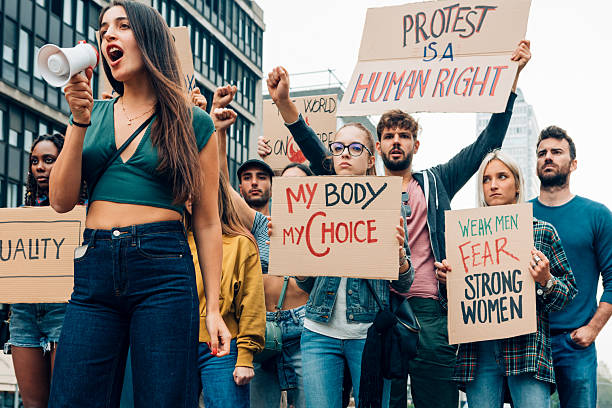 istock Crowd of young activists marching for their rights and equality 2223020828