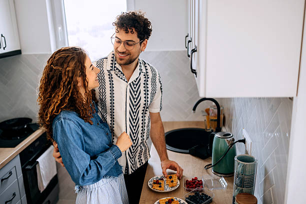 istock Smiling couple making blueberry waffles in home kitchen 2223021292
