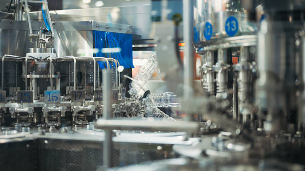 istock synchronized conveyor and multi-nozzle filling system in beverage or cosmetic production | automated stainless processing machine for mass packaging 2223022472