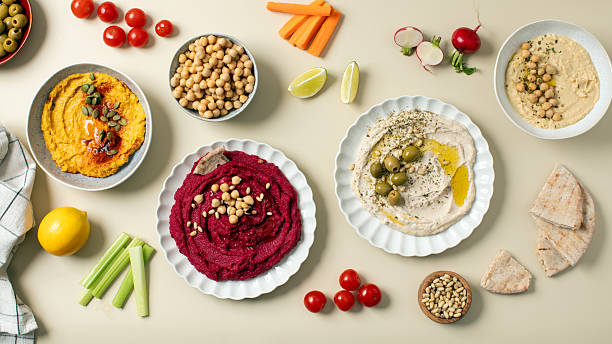 istock Different types of hummus in bowls and plates. Beetroot, pumpkin, chickpea and bean hummus. 2223026896