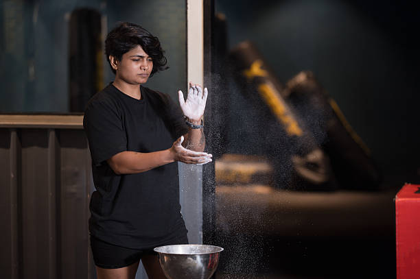 istock Muscular female coating her hands in powder chalk 2223027273
