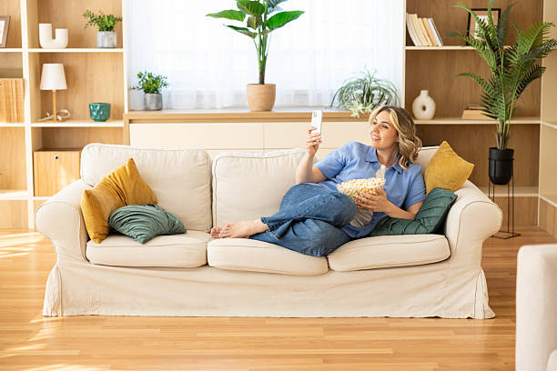 istock Content Woman Reacting on Couch with Phone 2223028877