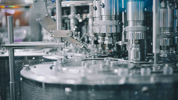 automated high speed liquid filling system with rotating multi-nozzle head machine in industrial production line for liquid packaging process with stainless steel mechanism and precision control