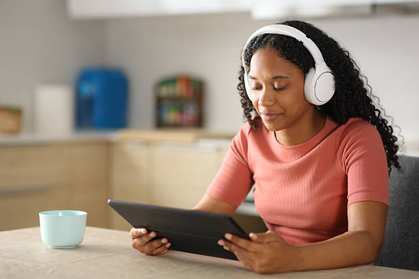istock Black woman watching media content in a digital tablet 2223031921