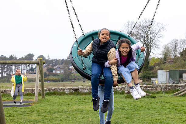istock Family Playing on Park Swing Basket 2223032111