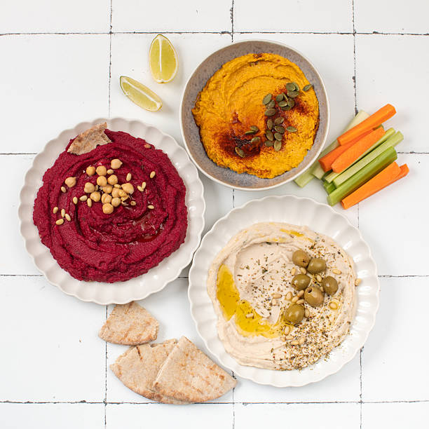 istock Different types of hummus in bowls and plates. Beetroot, pumpkin, chickpea and bean hummus. 2223034531