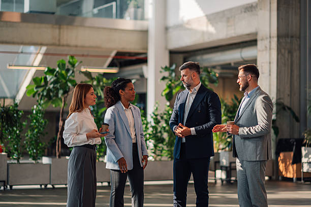 istock Businesspeople talking during coffee break in modern office 2223035252