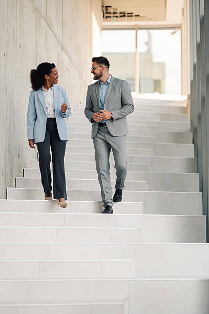 istock Businesspeople walking and talking on stairs 2223035573