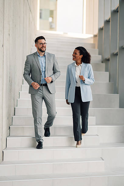 istock Businesspeople walking and talking on office stairs 2223035591