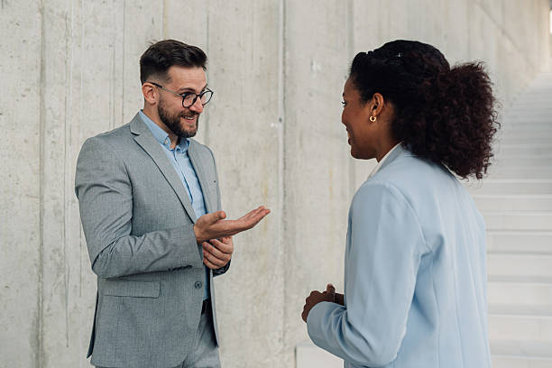 istock Two businesspeople talking and gesturing in modern office 2223035683
