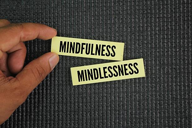 istock Two words mindfulness and mindlessness. represent two distinct modes of being. Mindfulness is characterized by a non-judgmental awareness of the present moment 2223035742