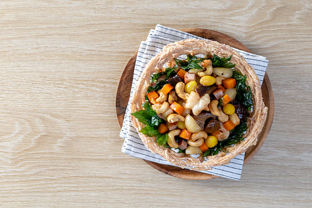 Stir fried mixed Chinese fruits and nuts on a wooden table