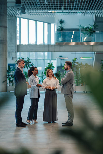 istock Business people talking in modern office building lobby 2223036166