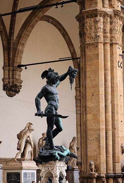 The statue of Perseus holding Medusa's head in Florence's Loggia dei Lanzi, showcasing Renaissance art and architecture.