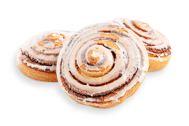 istock Three delicious cinnamon rolls bun glazed with sugar icing isolated on white background 2223037928