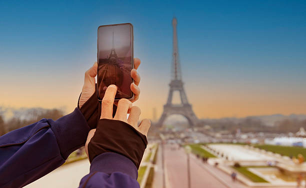 istock Tourist taking a picture with your mobile phone Eiffel tower with evening scene 2223040773