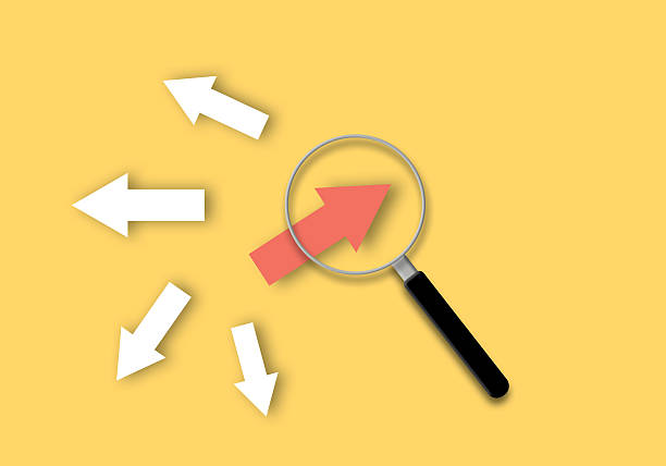 istock Magnifier focuses with red arrow on yellow background as metaphor for business creativity new idea, finding new normal way. 2223041580